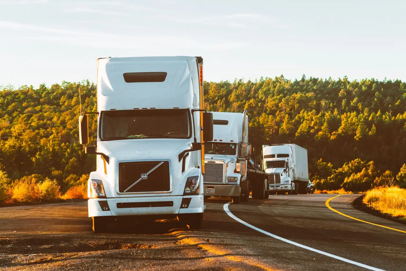 A semi truck hauling a trailer along a multi-lane highway